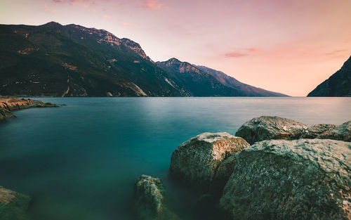 Scenic view of sea and mountains against sky