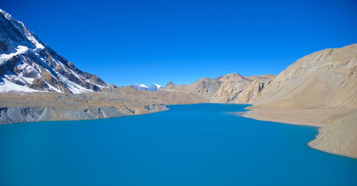 Panoramic view of lake and mountains against blue sky