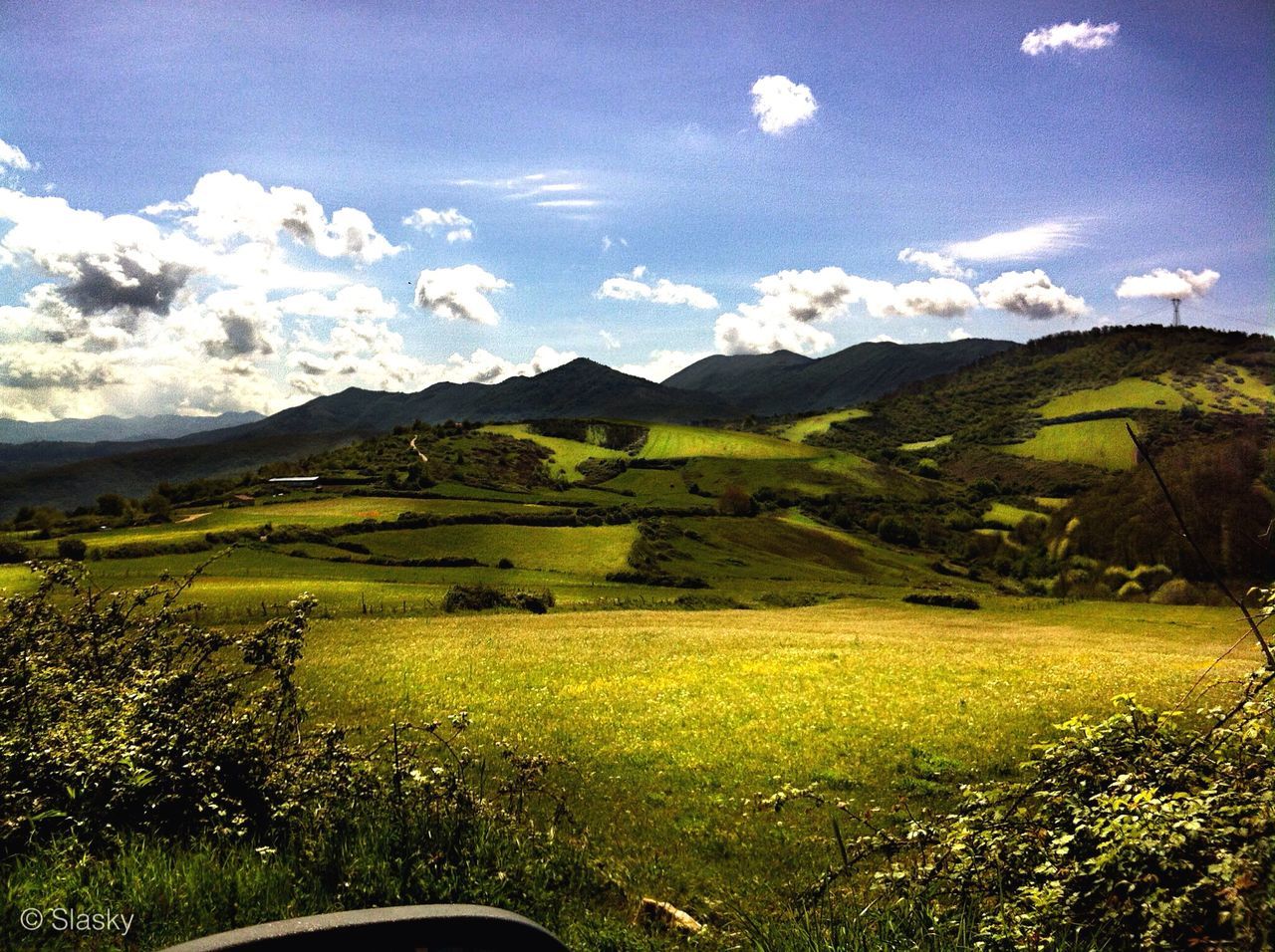 mountain, landscape, mountain range, tranquil scene, scenics, beauty in nature, sky, tranquility, grass, green color, nature, field, non-urban scene, cloud - sky, cloud, idyllic, growth, transportation, remote, countryside