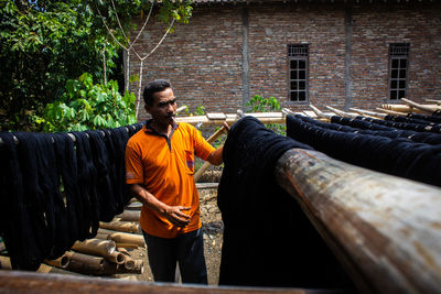  the craftsmen do  dyeing process of the fabric lurik in tringsing village,  java, indonesia