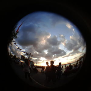 Silhouette of people against cloudy sky