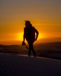 Silhouette of people at sunset