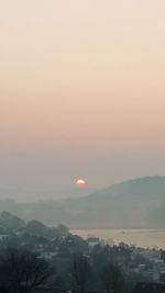 Scenic view of mountains against sky at sunset