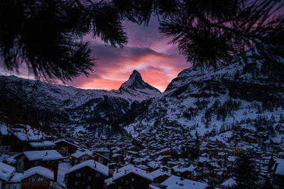 Scenic view of snowcapped mountains against sky during sunset