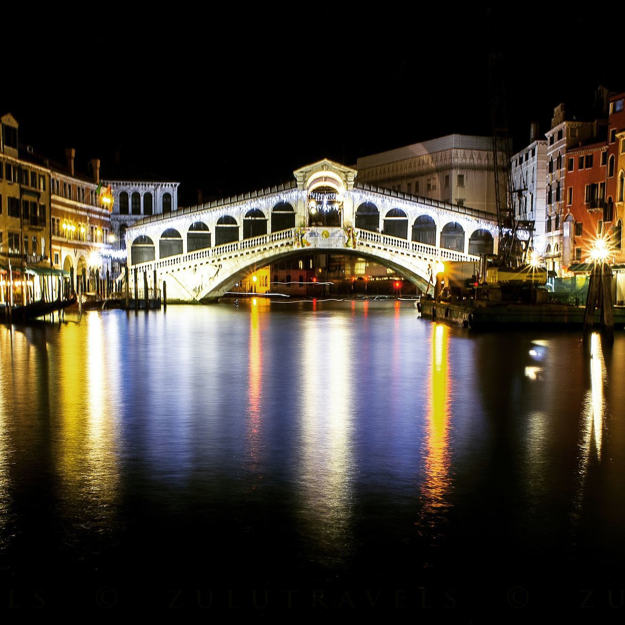 architecture, built structure, illuminated, water, night, building exterior, reflection, river, arch, bridge - man made structure, connection, waterfront, arch bridge, city, travel destinations, bridge, famous place, canal, clear sky, travel