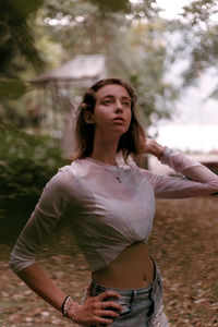 Portrait of young woman with arms raised