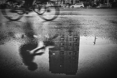 Reflection of city in puddle on street