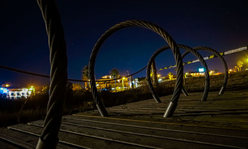 Bridge over illuminated city against sky at night