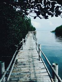 Staircase leading to river against sky