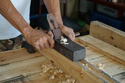 Woodwork and furniture making concept. carpenters are using spokeshave to decorate the woodwork.