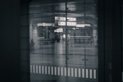 Text on railroad station platform seen through train window