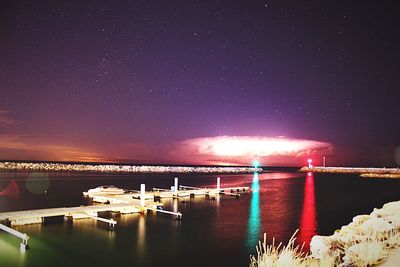 Scenic view of lake against sky at night