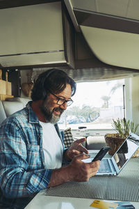 Young man using laptop while sitting at home