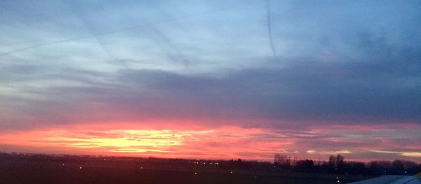 Scenic view of landscape against sky at sunset