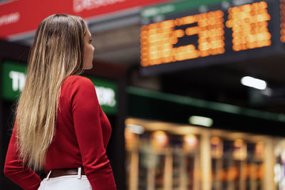 Rear view of woman standing at airport