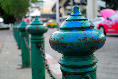 Close-up of weathered bollard on street