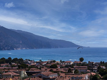 High angle view of townscape by sea against sky