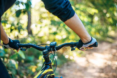 Close-up of man riding bicycle in forest