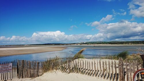 Scenic view of beach against blue sky