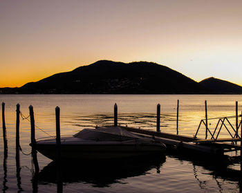 Boats in marina at sunset