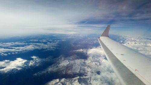Aerial view of aircraft wing against sky