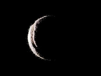 Close-up of light bulb over black background