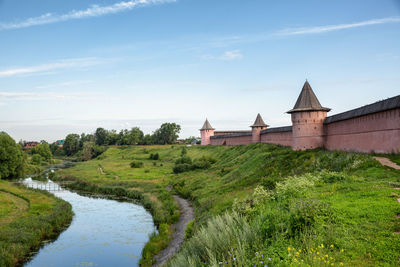 Scenic view of river by buildings against sky. spaso-euthymius monastery