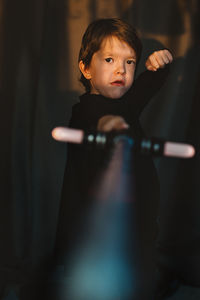Boy playing with sword at theater