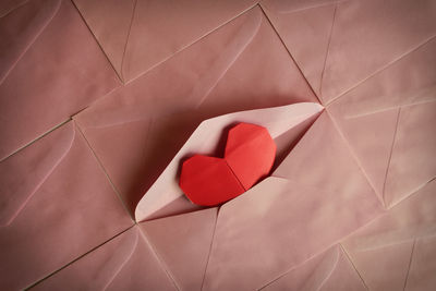 High angle view of red heart shape in envelope