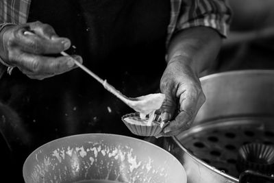 Midsection of man preparing food