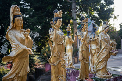 Statue of buddha against trees