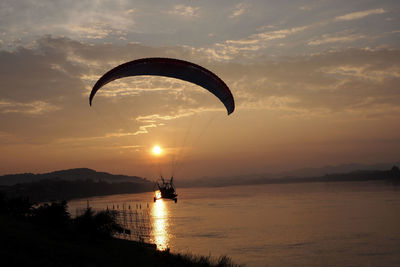 Scenic view of sunset over lake against sky