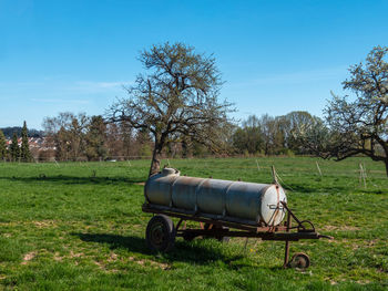 Horse cart on field against sky