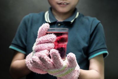 Close-up of boy holding cold juice drink