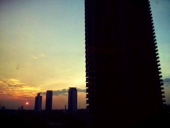 Modern buildings in city at sunset