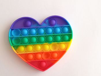 Directly above shot of multi colored balloons against white background