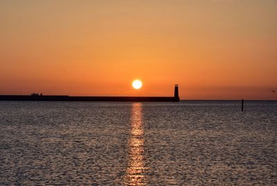 Scenic view of sea against romantic sky at sunset