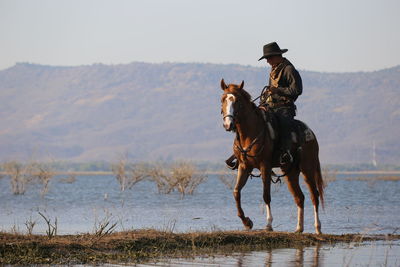 Man riding horse in lake