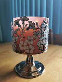 Close-up of electric lamp on table at home