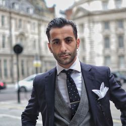 Portrait of businessman wearing nose ring on street against buildings