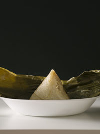 Close-up of food in plate against black background