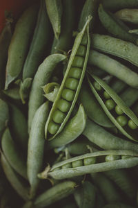 Open pods of raw green peas