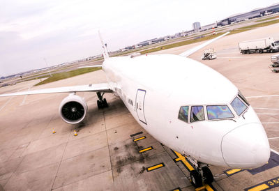 High angle view of airplane on airport runway against sky