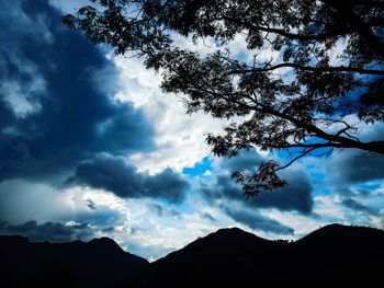 Low angle view of silhouette mountains against sky