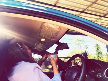 Rear view of man sitting in car