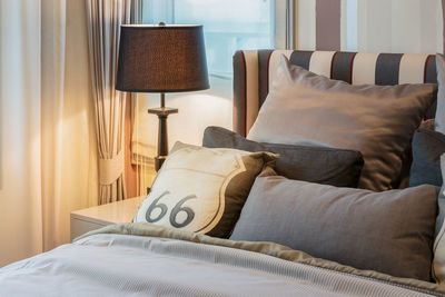 Midsection of man relaxing on bed at home