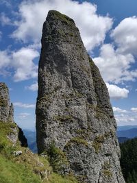 Low angle view of rock formation on land against sky