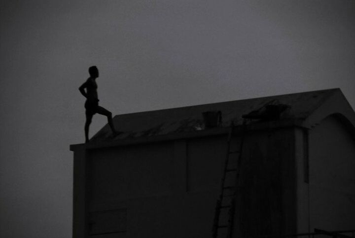 low angle view, architecture, built structure, building exterior, sky, copy space, silhouette, clear sky, statue, building, window, human representation, no people, sculpture, outdoors, old, house, art, art and craft, high section