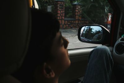 Rear view of man sitting in car