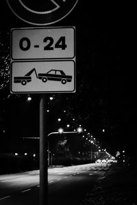 Illuminated road sign at night